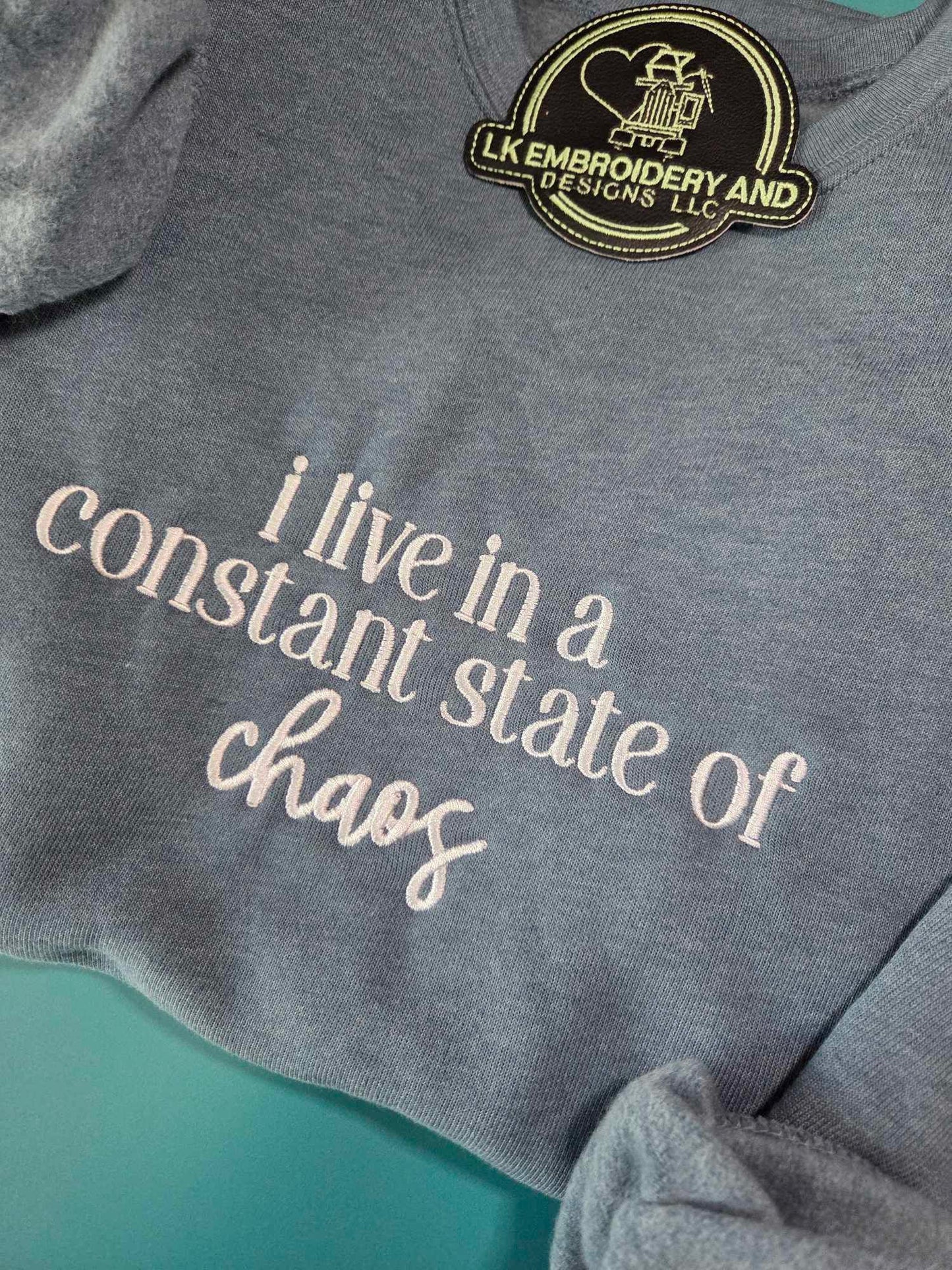 i live in a constant state of chaos Embroidered Crewneck Sweatshirt