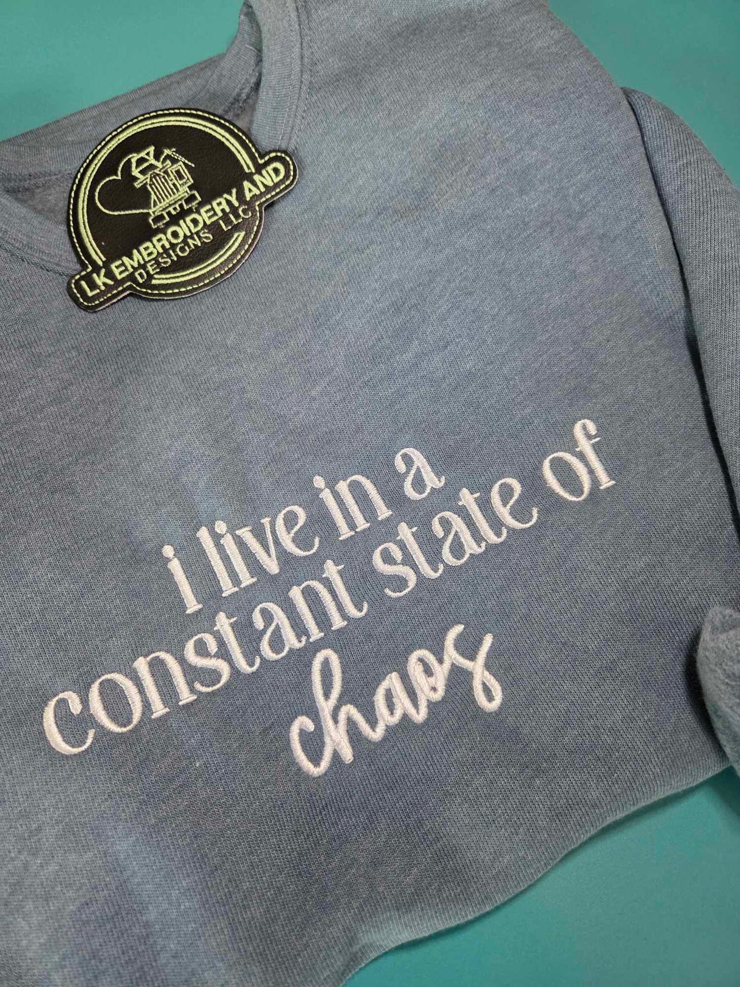i live in a constant state of chaos Embroidered Crewneck Sweatshirt