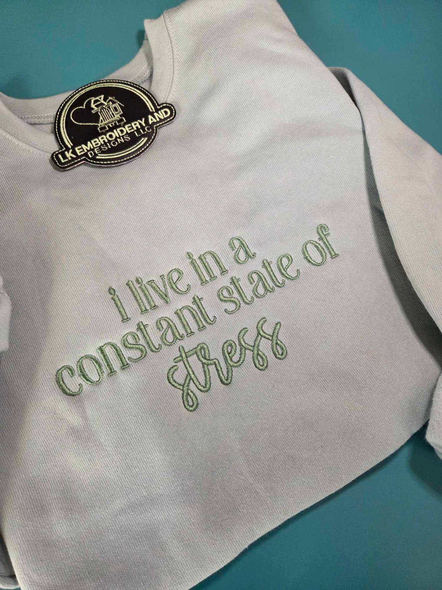 i live in a constant state of stress Embroidered Crewneck Sweatshirt