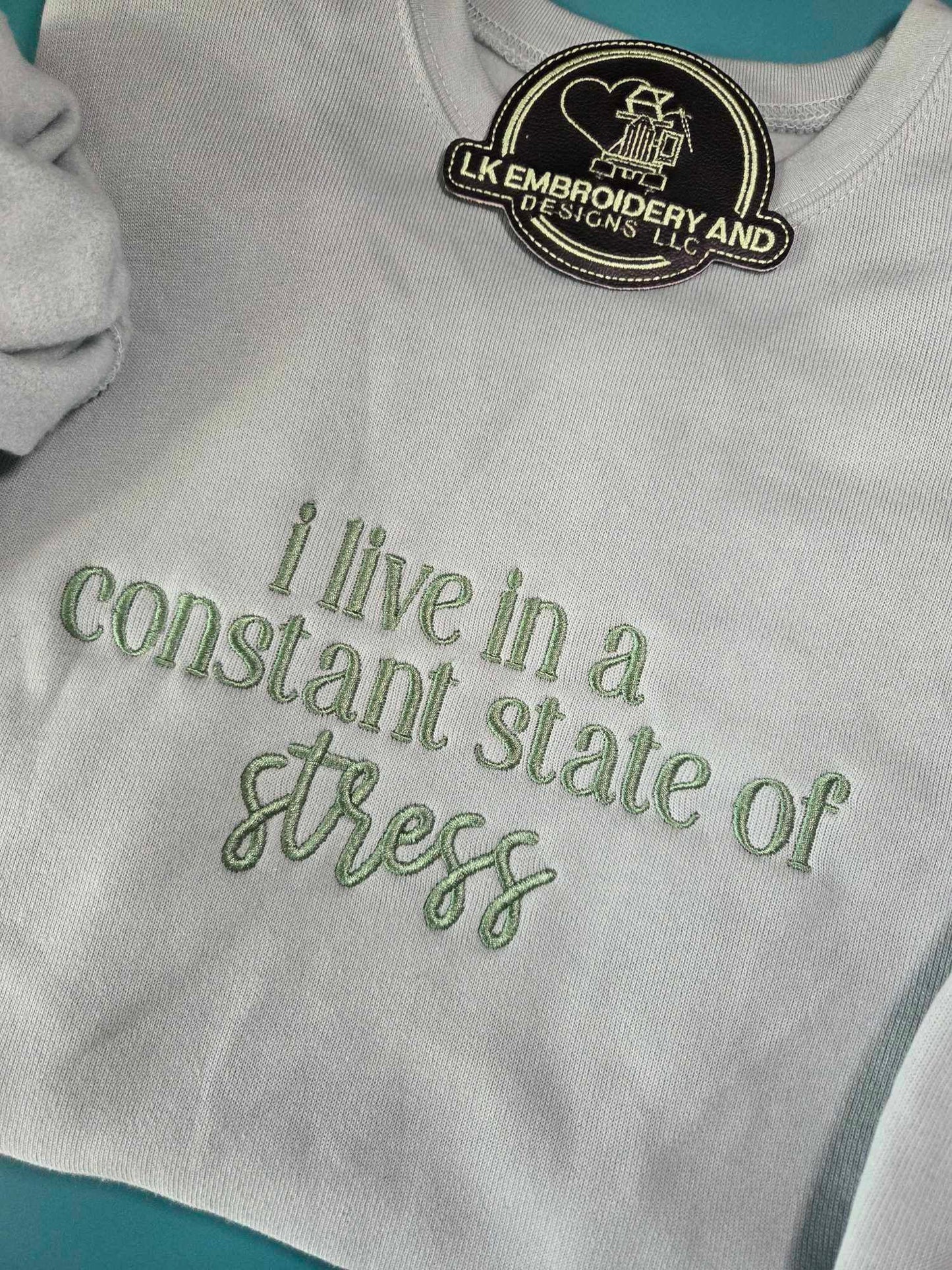 i live in a constant state of stress Embroidered Crewneck Sweatshirt